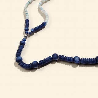 Necklace with blue beads on a beige background