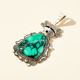 Turquoise stone pendant on a beige background