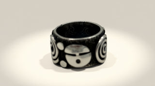 Black and white patterned ring on a light gray background