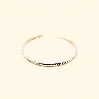 Silver bracelet on a beige background