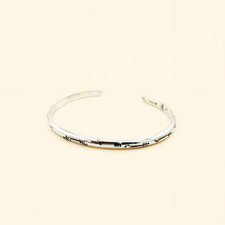 Silver bracelet on a beige background