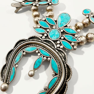 Turquoise pendant on a beige background