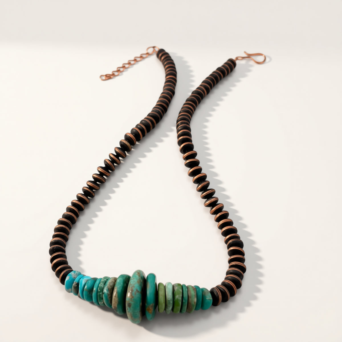 Necklace with brown and turquoise beads on a white background