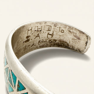 silver jewelry with stamp on a beige background
