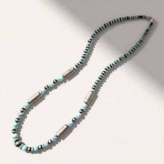 Necklace with blue and silver beads on a light background