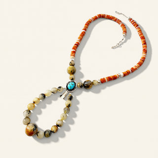 Necklace with beads and a turquoise stone on a white background
