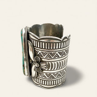 Silver bracelet  with intricate designs on a white background