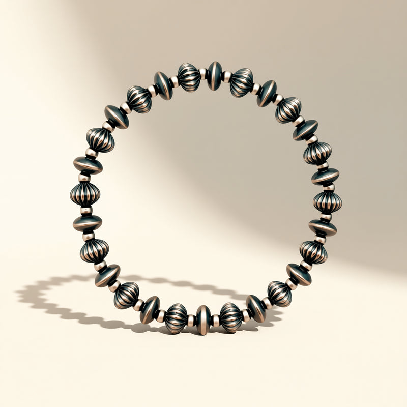 Silver beaded bracelet on a beige background