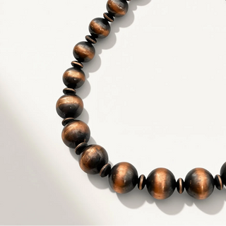 Wooden beaded necklace on a light gray background