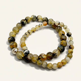 Round beaded bracelet with multicolor stones on a white background
