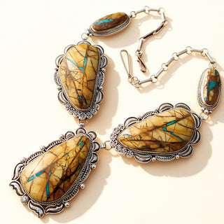 Necklace with stone pendants and silver chains on a beige background