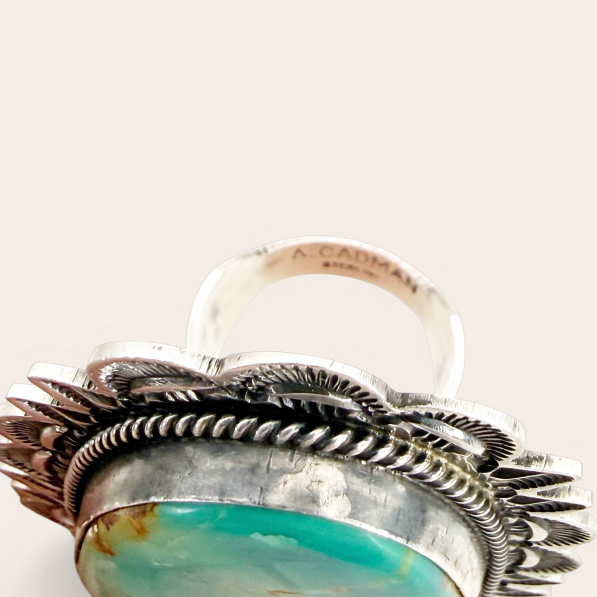Silver ring with turquoise stone on a white background