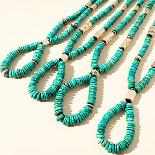 Necklaces with turquoise stones on a beige background