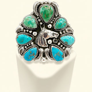 Silver cuff with turquoise stones on a white background