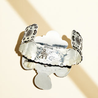 Silver cuff on a beige background