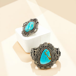 Turquoise stone jewelry set on a white stand