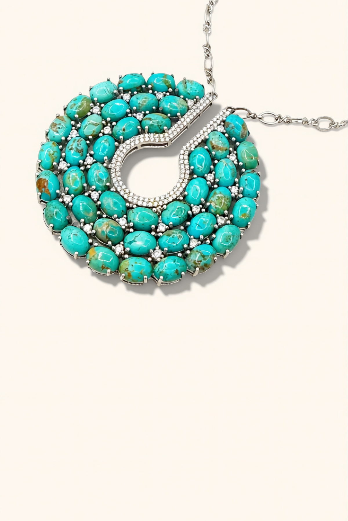 Turquoise necklace with silver clasp on a beige background