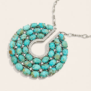Turquoise necklace with silver accents on a white background