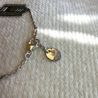 Close-up of a bracelet on a textured beige surface