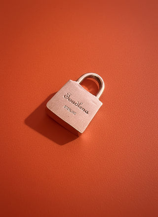 Silver padlock on a textured surface