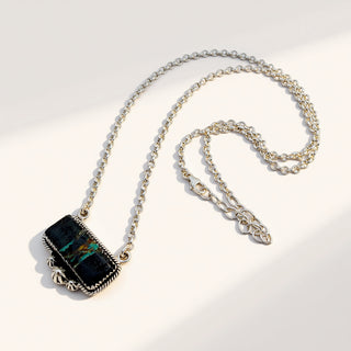 Necklace with a black pendant on a light gray background