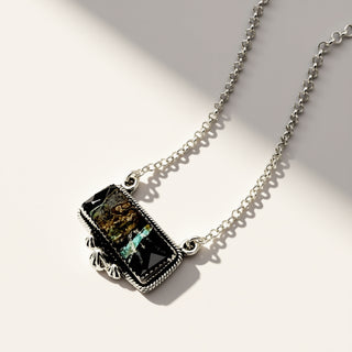 Necklace with a rectangular pendant on a light background