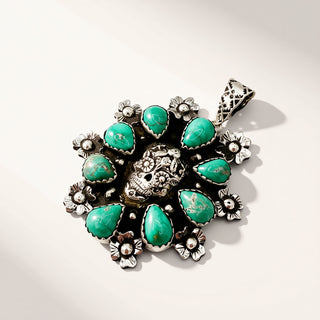 Silver and turquoise pendant on a light background