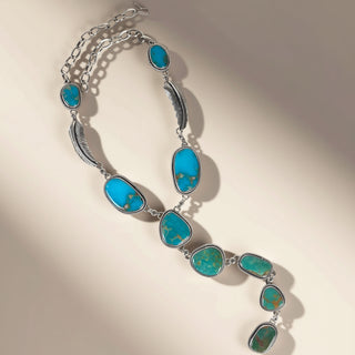 Turquoise stone necklace on a beige background