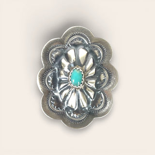 Silver concho with turquoise center on a white background