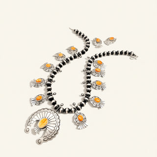 Necklace with orange accents on a white background