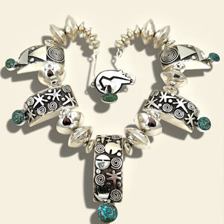 Pair of silver earrings with intricate designs on a beige background