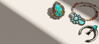 Three turquoise jewerly on a beige background