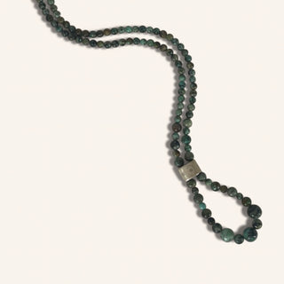 Beaded necklace with a silver clasp on a white background