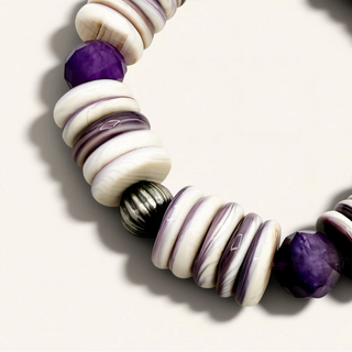 Bracelet with purple and white beads on a light background