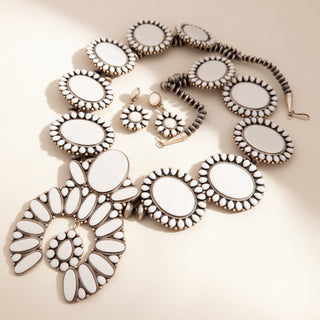 Jewelry set with necklace and earrings on a beige background