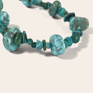 Turquoise beaded necklace on a white background