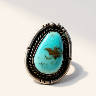 Turquoise ring with silver band on a white background