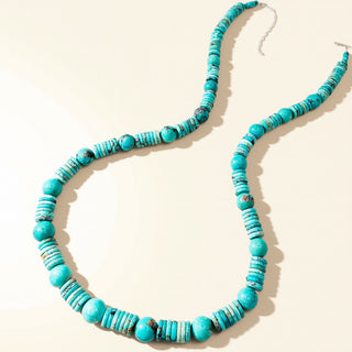turquoise beaded necklace on a beige background