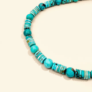 turquoise beaded necklace on a beige background
