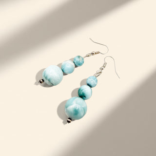 Turquoise beaded earrings on a light background
