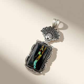 Silver pendant with a colorful central stone on a beige background