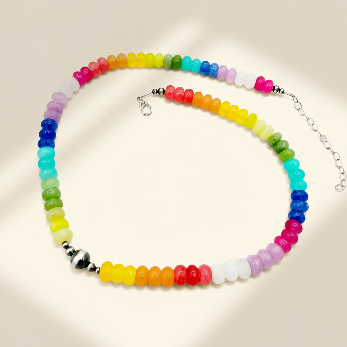 Colorful beaded necklace on a beige background