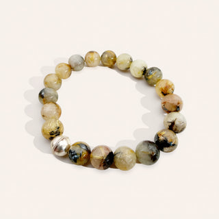 Beaded bracelet with natural stone beads on a light background