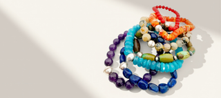 Colorful beaded bracelets on a white background