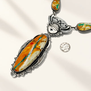Necklace with large stone pendant and smaller stones on a light background