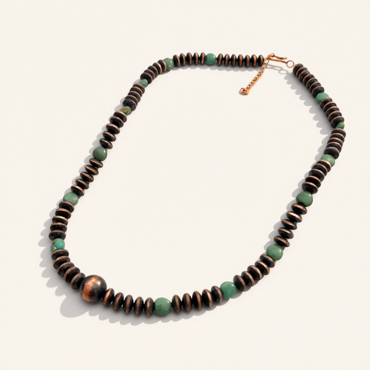 Necklace with brown and green beads on a white background