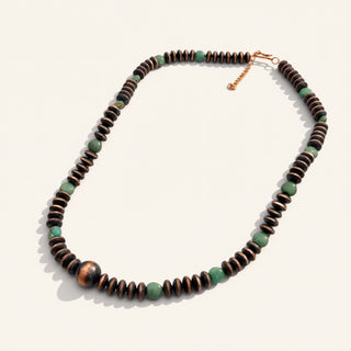 Necklace with brown and green beads on a white background