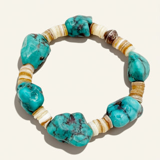 Turquoise stone and beige bead bracelet on a white background