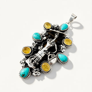A silver-toned Southwestern-style pendant featuring turquoise and yellow gemstone accents, photographed on a clean white background.