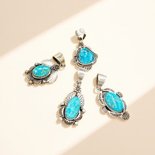 Jewelry set with turquoise stones and silver frames on a beige background